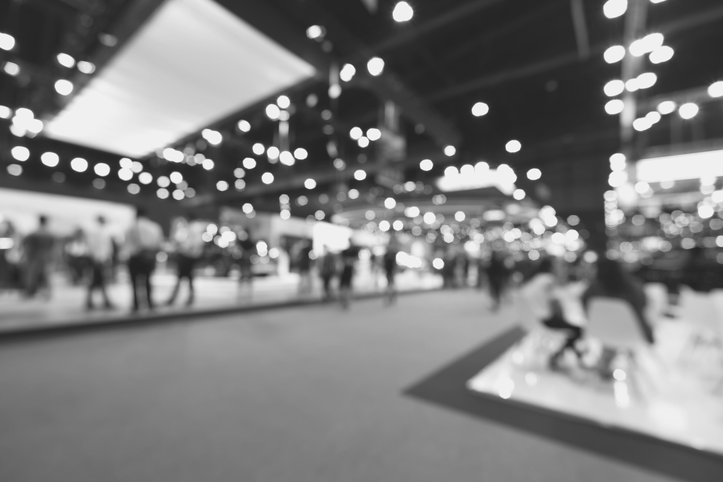 Blurred, defocused background of public event exhibition hall. Business trade show or commercial activity concept